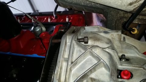 1985 Ford Bronco - Close-up view of engine and transmission components, a Supermotors logo in the lower right corner.