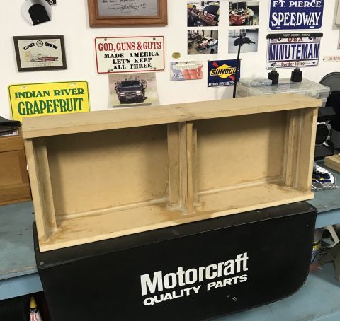 2014 Dodge 1500 - A wooden shelf unit is placed on top of a black box with 'Motorcraft Quality Parts' printed on it.