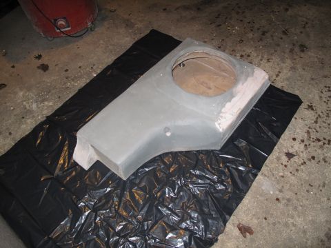 1994 Ford Bronco - A custom-made subwoofer enclosure is shown on a black plastic sheet on a concrete floor.