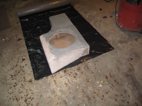 1994 Ford Bronco - A custom-built subwoofer enclosure is prepared for installation, resting on a black tarp on a garage floor.