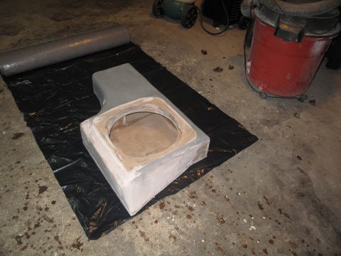 1994 Ford Bronco - A custom subwoofer enclosure is being built on black plastic sheeting in a garage.