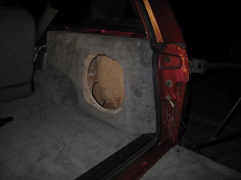 1994 Ford Bronco - A custom subwoofer enclosure is installed in the rear cargo area of a vehicle.