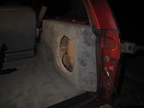1994 Ford Bronco - Custom subwoofer box installed in the rear cargo area of a red 1994 Ford Bronco.