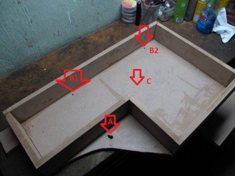 1994 Ford Bronco - A custom-built subwoofer enclosure is shown, with red arrows indicating different construction points.