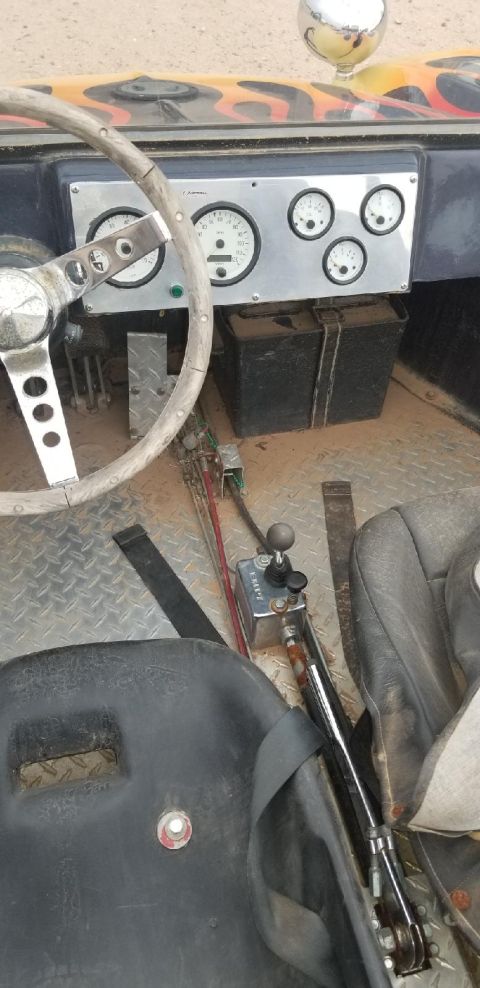 1970 Volkswagen Beetle - The interior of a custom vehicle features a flame-painted dashboard and aftermarket gauges.