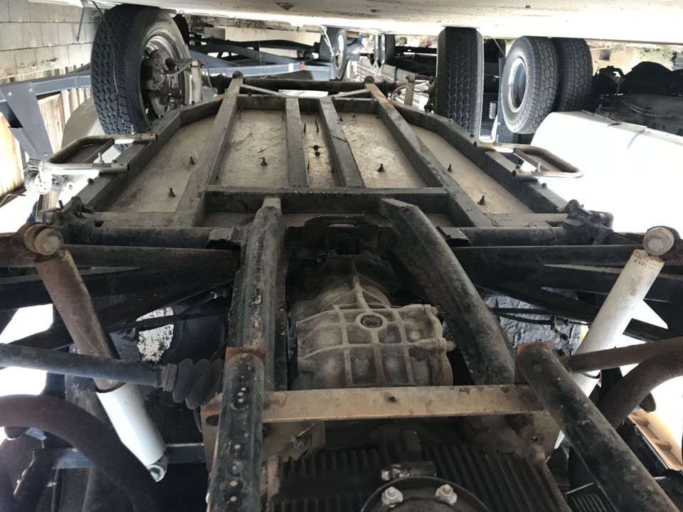 Underside view of a vehicle chassis with transmission and suspension components visible