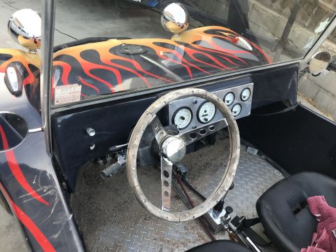 1970 Volkswagen Beetle - Interior view of a custom hot rod with flame graphics and a vintage steering wheel.
