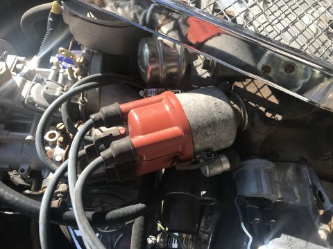 1970 Volkswagen Beetle - Close-up view of an engine bay, focusing on the distributor cap and associated wiring.