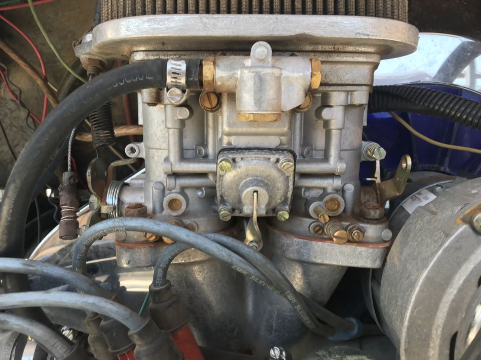 Close-up of a carburetor and engine components