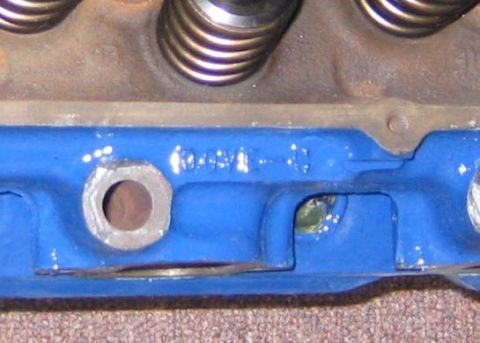 1978 Ford Bronco - Close-up of a blue engine component, showing valve springs and stamped markings.