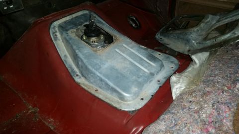1985 Ford Bronco - The interior of a vehicle shows a close-up of the floor console area with a manual transmission shifter and a metal plate surrounding it. T…