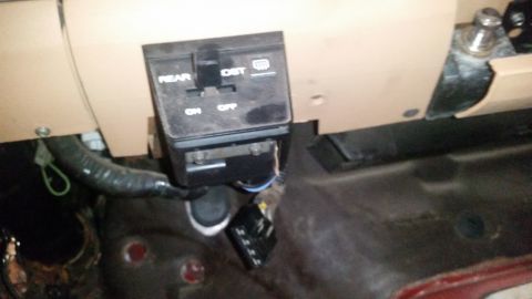 1985 Ford Bronco - A close-up interior shot shows a black switch panel with the labels "REAR", "DST", "ON", and "OFF". The panel appears to be part of a vehic…