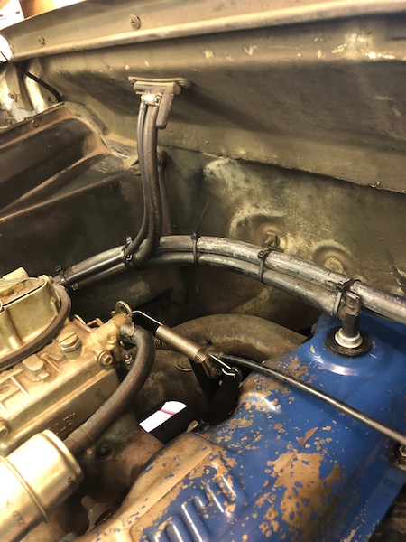 1981 Ford Bronco - The image shows a close-up view of the engine bay of a classic vehicle, likely a 1981 Ford Bronco, with various hoses and cables neatly org…