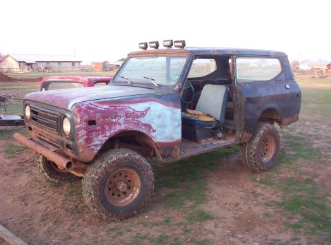1988 Ford Bronco - This heavily modified International Scout II features custom paintwork and off-road enhancements, including roof-mounted lights and a bumpe…