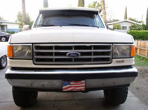 White Ford Bronco front view with chrome grille and 4x4 badge