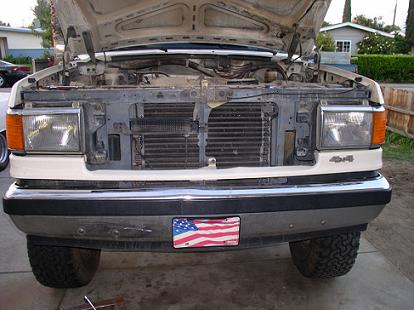 1988 Ford Bronco - Front view of a 1987 Ford F-Series truck with the hood up, revealing the engine bay and radiator.