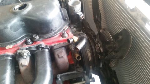 1985 Ford Bronco - The image shows a close-up view of an engine bay, focusing on the radiator and part of the engine. A fan is visible in front of the radiato…