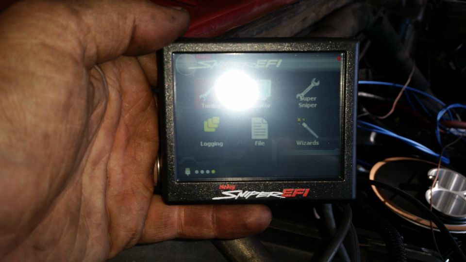 Holley Sniper EFI handheld tuner displaying menu options.