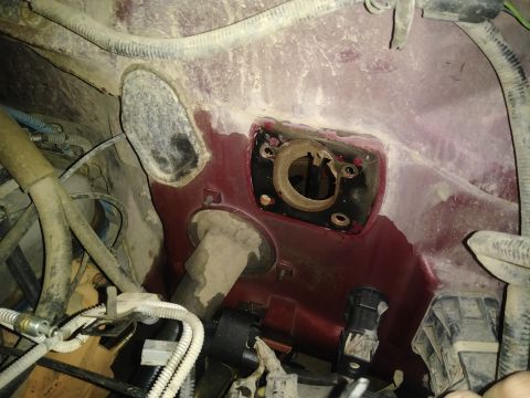 1996 Ford Bronco - This is a close-up view of the engine bay of a 1996 Ford Bronco, showing the firewall area with various hoses, wires, and a circular openin…