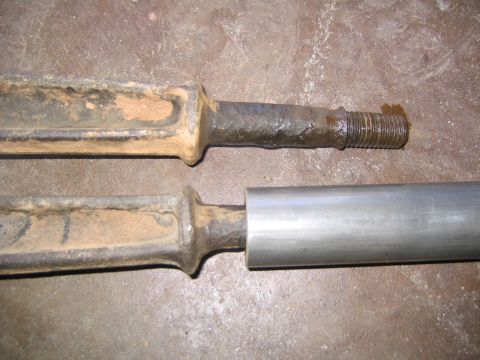 1978 Ford Bronco - Comparison of two metal rods, one showing rust and a threaded end.
