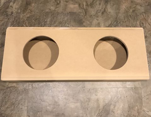 1995 Ford Bronco - A wooden enclosure with two circular cutouts sits on a tiled floor.