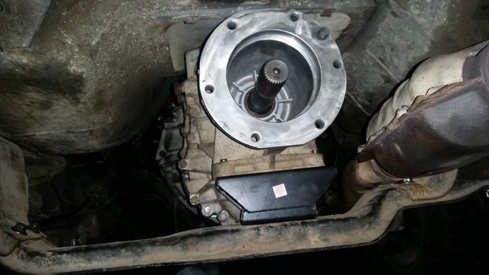 Underside of vehicle showing transmission, transfer case, and exhaust.