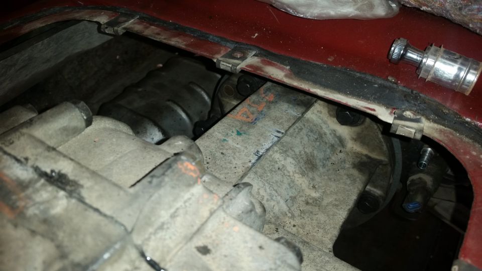 Underside view of vehicle transmission and transfer case assembly with visible bolts and grime.