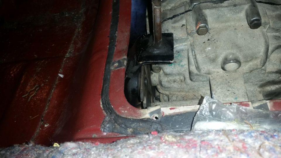 Transmission housing with black bracket and red interior paneling