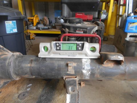 1992 Ford Bronco - A digital level is placed on a metal axle housing, showing a reading of 1.1 degrees. The axle appears to be part of a vehicle restoration o…
