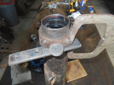 1992 Ford Bronco - A close-up shot shows a metal pipe being held in place by a clamp, with a bracket attached to the pipe. The bracket has two threaded holes…