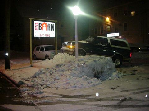 1994 Ford Bronco - A 1994 Ford Bronco is parked in the snow outside a Pizza Barn at night, with another car visible in the background.