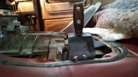 1985 Ford Bronco - A close-up view shows a transfer case with a shift lever attached, positioned within the interior of a vehicle. The surrounding area appear…