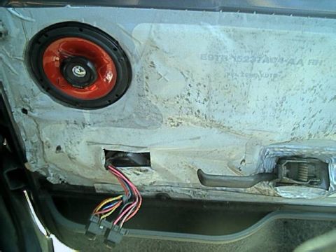 1989 Ford Bronco - Inside of a door with the trim panel removed, showing the white plastic water shield stamped with Ford part number E9TB-15237A04-AA RH, a r…