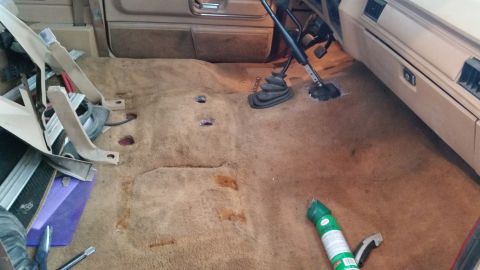 1985 Ford Bronco - Interior view of a 1985 Ford Bronco with the carpet pulled up for cleaning or modification.