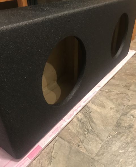 1995 Ford Bronco - Car subwoofer box with textured finish and openings for speakers.