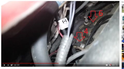 Engine bay video screenshot with red arrows numbered 4 and 6 pointing at components