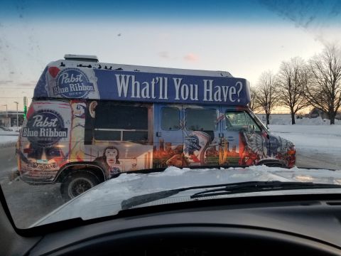 1995 Ford Bronco - A van decorated with Pabst Blue Ribbon advertisements and the question "What'll You Have?" is seen in a snowy environment.