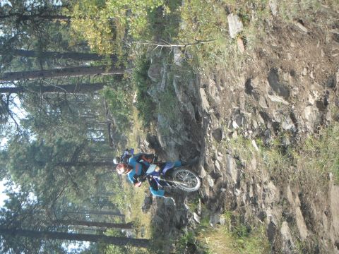 1987 Honda XL600R - A rider navigates a challenging rocky terrain on a motorcycle, with another rider following closely behind.
