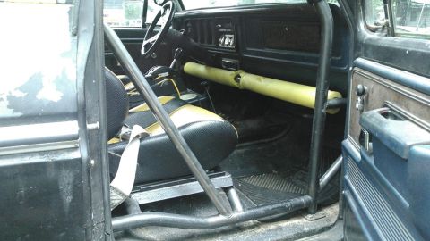 1978 Ford Bronco - The interior of a 1978 Ford Bronco shows custom roll cage and two-tone seats.