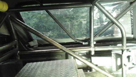 1978 Ford Bronco - Interior view of a vehicle's roll cage and diamond plate flooring, with a "SUPERMOTORS" logo visible.