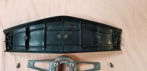 1970 Chevrolet Camaro - Black plastic trim piece with visible text and mounting hardware, likely an automotive part.