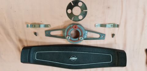 1970 Chevrolet Camaro - Disassembled steering wheel horn pad and associated components laid out on a surface.