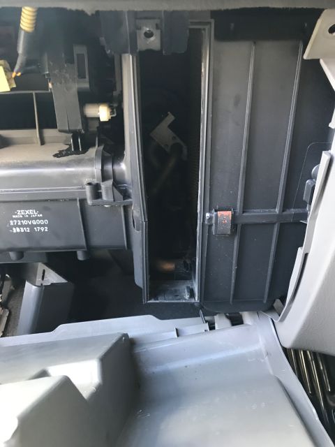 2002 Nissan Quest - This photo shows the internal components of a vehicle's air conditioning and heating system, likely near the glove box area.
