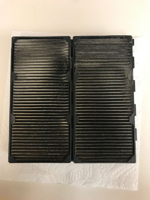2002 Nissan Quest - A pair of heavily soiled cabin air filters are shown, indicating a need for replacement.