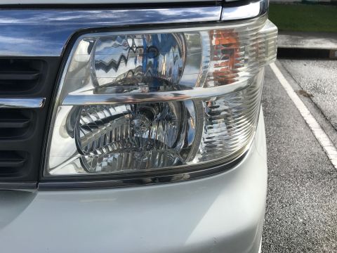 2002 Nissan Quest - Close-up of the front headlight and grille of a 2002 Nissan Quest.