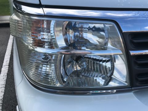 2002 Nissan Quest - Close-up of the front headlight and chrome grille on a 2002 Nissan Quest.