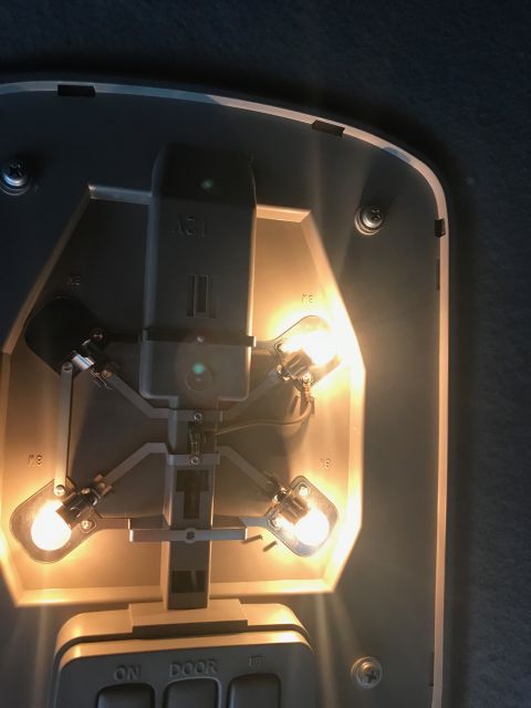 2002 Nissan Quest - Close-up of a vehicle's interior dome light assembly, showing the bulb sockets and wiring.