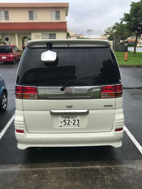 2002 Nissan Quest - A white minivan is parked in a lot, showing its rear end and license plate.