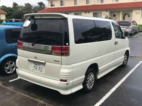 2002 Nissan Quest - Rear view of a white minivan parked next to a blue vehicle. The license plate is visible.