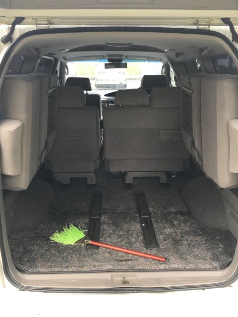 2002 Nissan Quest - Interior view of a 2002 Nissan Quest with seats folded and a broom on the floor.